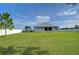 Large grassy backyard with a spacious area for recreation at 4439 Devinshire Fields Loop, Plant City, FL 33567