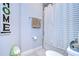 Suburban bathroom with shower and striped curtain at 4439 Devinshire Fields Loop, Plant City, FL 33567