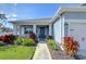 Inviting front porch with blue door and lush landscaping at 4439 Devinshire Fields Loop, Plant City, FL 33567