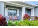 Inviting front porch with a swing and lush landscaping at 4439 Devinshire Fields Loop, Plant City, FL 33567