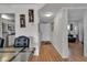 Clean hallway with light wood flooring, offering views of kitchen and living room at 4650 Cove Cir # 509, St Petersburg, FL 33708