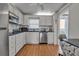 White kitchen with stainless steel appliances and granite countertops at 4650 Cove Cir # 509, St Petersburg, FL 33708