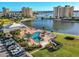 An aerial view of a community pool, with surrounding landscaping and parking at 4650 Cove Cir # 509, St Petersburg, FL 33708