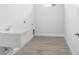 Bright laundry room featuring a sink and modern flooring, ready for your washer and dryer at 5112 Lake Toscana Dr, Wimauma, FL 33598