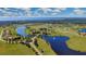 Stunning aerial view of a conservation community with large lots, a central pond and luxurious homes at 5214 Lake Venice Dr, Wimauma, FL 33598