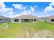 Aerial view of backyard, showing lawn and the back of the home at 5214 Lake Venice Dr, Wimauma, FL 33598