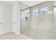 Modern glass shower features mosaic tile flooring, dual shower heads, and natural light at 5214 Lake Venice Dr, Wimauma, FL 33598