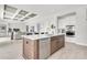 Contemporary kitchen island with a stainless steel dishwasher, stylish cabinetry, and a view of the open living space at 5214 Lake Venice Dr, Wimauma, FL 33598