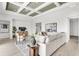 Open living room boasting a decorative ceiling, tile floors, and natural lighting at 5214 Lake Venice Dr, Wimauma, FL 33598