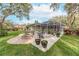 Landscaped backyard with fire pit and patio at 6017 Hammock Hill Ave, Lithia, FL 33547