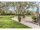 Relaxing brick patio with fire pit, surrounded by lush landscaping at 6017 Hammock Hill Ave, Lithia, FL 33547