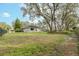 Large backyard with grassy area and mature trees at 6017 Hammock Hill Ave, Lithia, FL 33547