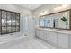 Elegant bathroom with granite countertops, a soaking tub, and a walk-in shower at 6017 Hammock Hill Ave, Lithia, FL 33547