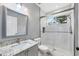 Modern bathroom with a large walk-in shower and granite vanity at 6017 Hammock Hill Ave, Lithia, FL 33547