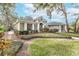 One-story home with lush landscaping and a stone pathway at 6017 Hammock Hill Ave, Lithia, FL 33547