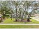 Landscaped front yard with mature trees and curb appeal at 6017 Hammock Hill Ave, Lithia, FL 33547