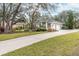 House exterior with driveway and landscaping at 6017 Hammock Hill Ave, Lithia, FL 33547