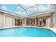 Relaxing pool area with covered patio and lounge chairs at 6017 Hammock Hill Ave, Lithia, FL 33547