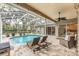 Relaxing pool area with screened enclosure and patio furniture at 6017 Hammock Hill Ave, Lithia, FL 33547