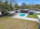 Large backyard with pool, patio, and covered structures at 6040 Antrim St, New Port Richey, FL 34653