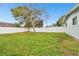 Spacious backyard with grassy lawn and white vinyl fence at 6040 Antrim St, New Port Richey, FL 34653