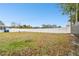 Large backyard with grassy lawn and white vinyl fence at 6040 Antrim St, New Port Richey, FL 34653