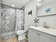 Bathroom with marble shower and modern vanity at 6040 Antrim St, New Port Richey, FL 34653