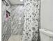 Marble shower with seashell-themed shower curtain at 6040 Antrim St, New Port Richey, FL 34653