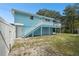 Light blue house with a deck and fenced backyard at 6416 Finance Ave, Weeki Wachee, FL 34607