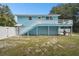 Light blue house with deck and fenced backyard at 6416 Finance Ave, Weeki Wachee, FL 34607