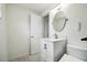 Clean bathroom with white vanity, toilet and a large mirror at 6416 Finance Ave, Weeki Wachee, FL 34607