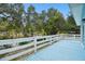 Blue deck overlooking a tree-filled backyard at 6416 Finance Ave, Weeki Wachee, FL 34607