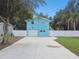 Cute light blue house with a white fence and driveway at 6416 Finance Ave, Weeki Wachee, FL 34607