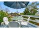 Enjoy outdoor dining on this quaint patio with metal table and chairs at 6800 Sanderling Ln, Hudson, FL 34667