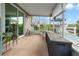 Relaxing screened porch with tiled floor, wicker chairs, and water views at 6800 Sanderling Ln, Hudson, FL 34667