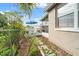 Landscaped side yard with stone pathway and lush greenery at 6800 Sanderling Ln, Hudson, FL 34667