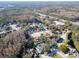 Aerial view of a residential neighborhood with houses, trees, and a road at 7120 Hideaway Trl, New Port Richey, FL 34655