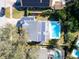 Aerial view showcasing home, pool, and solar panels at 7120 Hideaway Trl, New Port Richey, FL 34655