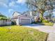 House exterior with a two-car garage and driveway at 7120 Hideaway Trl, New Port Richey, FL 34655