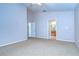 Well-lit bedroom with carpet flooring and adjacent bathroom at 7136 Colony Pointe Dr, Riverview, FL 33578