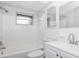 Clean bathroom, white tile, and updated vanity at 7930 Datura Lane Ln, New Port Richey, FL 34653