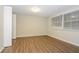 Well-lit bedroom with wood-look flooring and a large window at 7930 Datura Lane Ln, New Port Richey, FL 34653