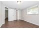 Bedroom with wood-look flooring and built-in shelving at 7930 Datura Lane Ln, New Port Richey, FL 34653