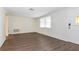 Living room featuring wood-look flooring and a view to the front door at 7930 Datura Lane Ln, New Port Richey, FL 34653