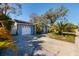 Classic home with white garage door, white-columned entry, palm trees, and a spacious driveway at 8307 Boxwood Dr, Tampa, FL 33615