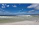 Peaceful beach view with ocean waves and blue sky at 8581 W Gulf Blvd, Treasure Island, FL 33706