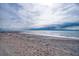 Beachfront view with ocean waves and cloudy sky at 8581 W Gulf Blvd, Treasure Island, FL 33706