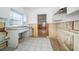 Dated kitchen with worn cabinets and tiled floor, needs updating at 8581 W Gulf Blvd, Treasure Island, FL 33706