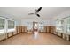 Large living room with hardwood floors and ceiling fan at 8581 W Gulf Blvd, Treasure Island, FL 33706