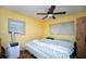 Bedroom with a double bed, ceiling fan, and portable AC unit at 8742 Narcissus Ave, Seminole, FL 33777